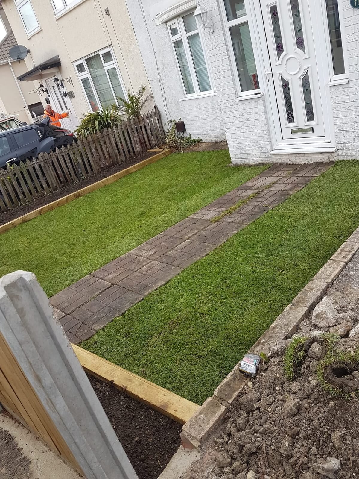 Artificial lawn and paving in a front garden by Ashurst and Sons Roofing