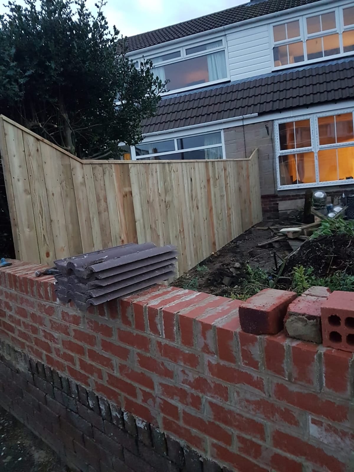 Fresh garden fencing above a brick boundary wall by Ashurst and Sons Roofing
