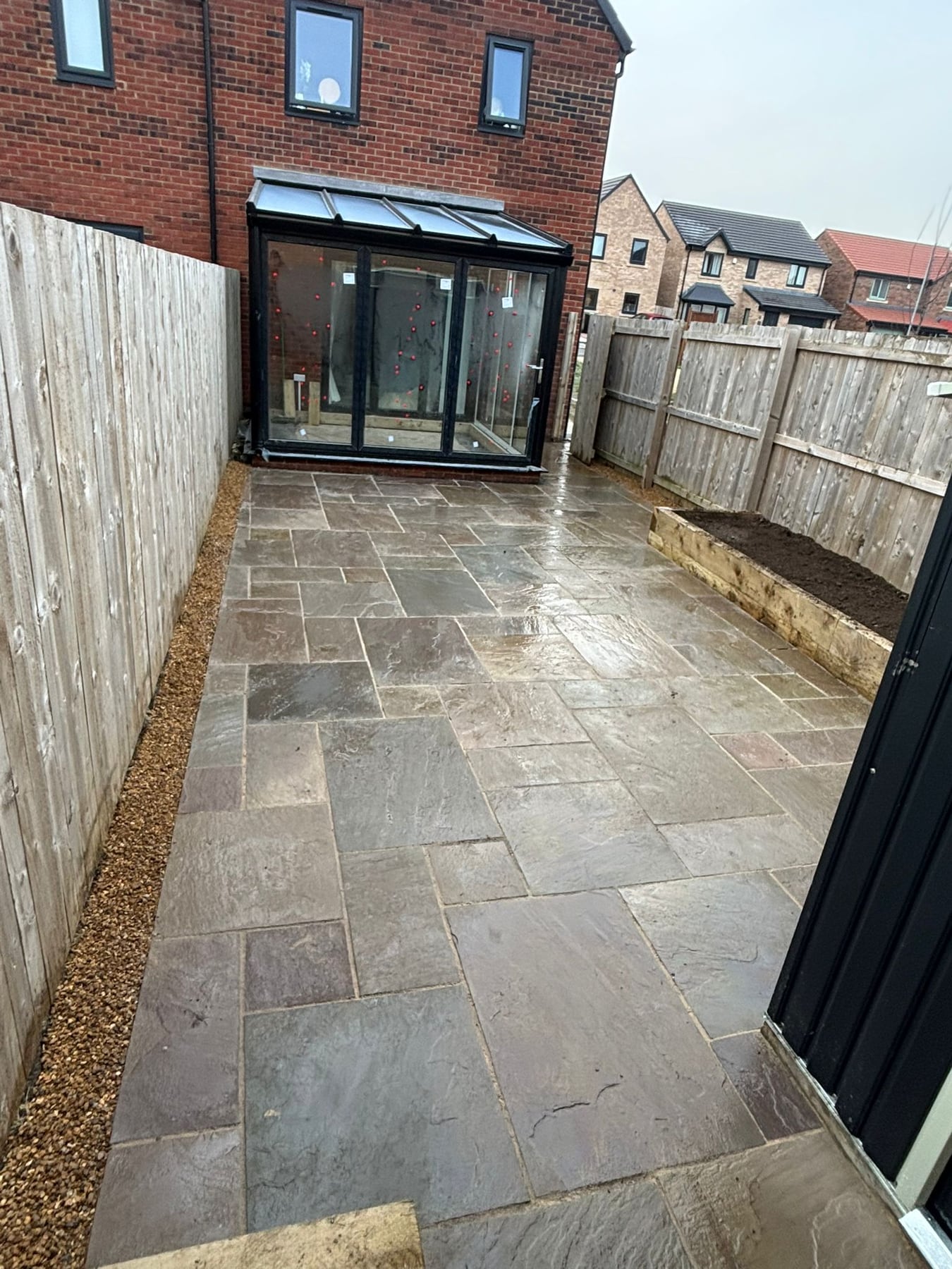 Finished patio paving and fencing by Ashurst and Sons Roofing