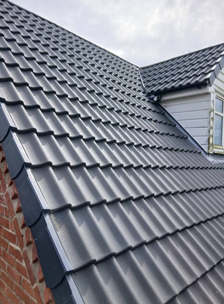 Close up of new grey roof tiles fitted by Ashurst and Sons Roofing